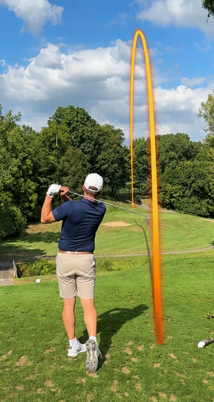 Gold ball-flight trail over a golf fairway